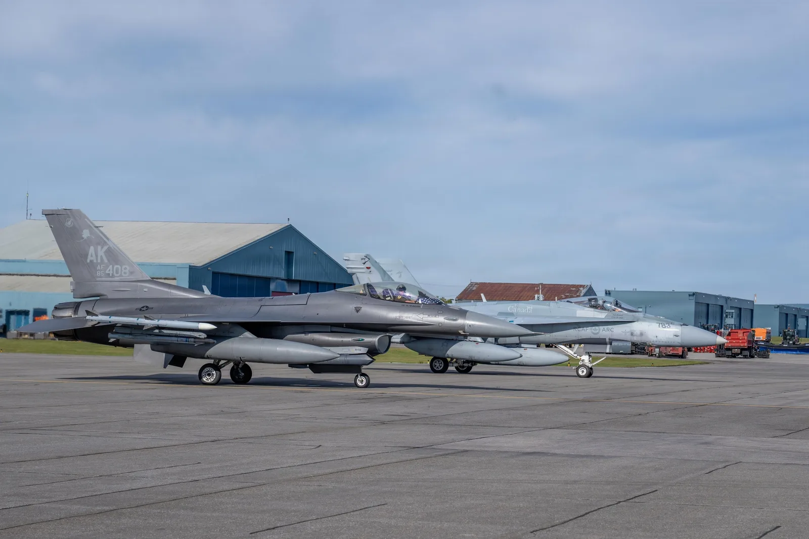 U.S. Air Force F-16 and Royal Canadian Air Force CF-18 beside one another on the flight line at 5 Wing Goose Bay.