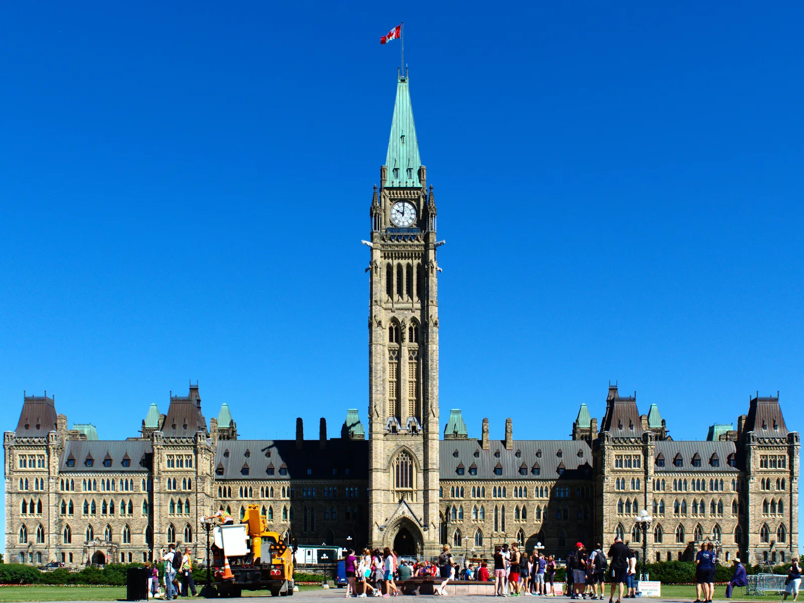 Centre Block and the Peace Tower on Parliament Hill in Ottawa, with a Canadian flag above the tower.