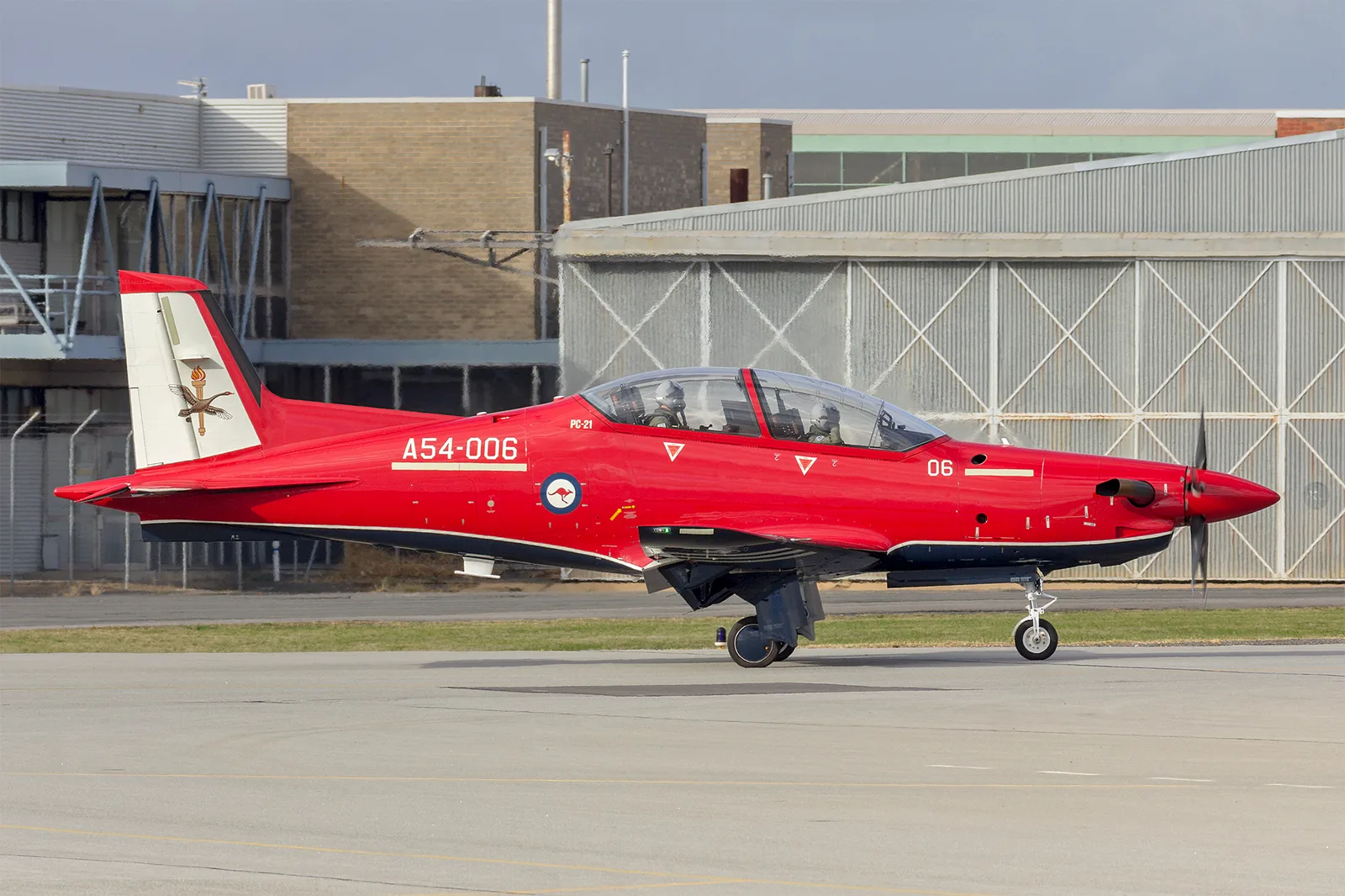 A red Royal Australian Air Force Pilatus PC-21 taxis at Wagga Wagga Airport.