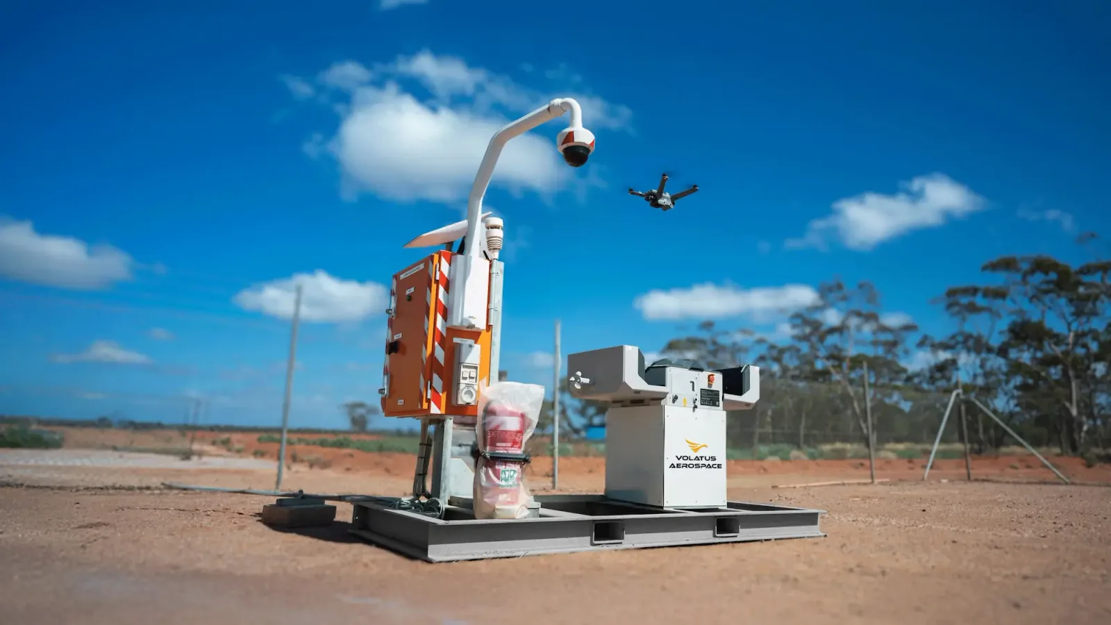 A drone above automated docking equipment branded Volatus Aerospace.