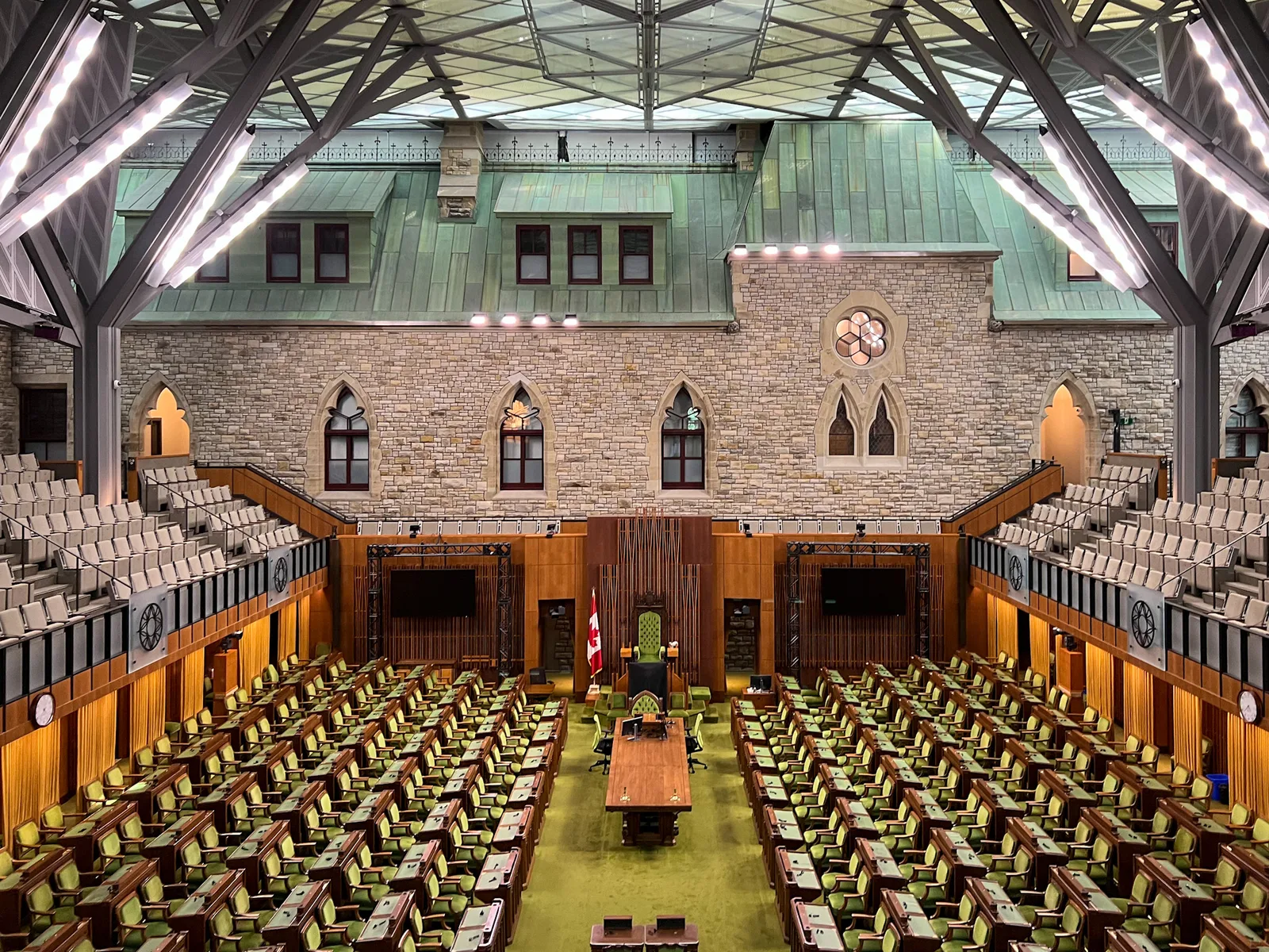 House of Commons chamber in the West Block on Parliament Hill in Ottawa, with green seats and the Speaker’s chair.
